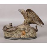 An early 20th century novelty painted cast iron mechanical money box. Modelled in the form of a bird