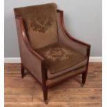 An Edwardian upholstered tub armchair with mahogany frame.