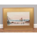 A gilt framed watercolour, beach scene with sail boats and figures. Signed indistinct. 31cm x 50cm.