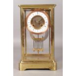 A brass and glass Japy Freres mantel clock. With Roman numeral markers, chiming on a coiled gong,
