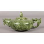 A Chinese jade teapot. The spout formed as a birds head and the handle as a dragons head. Length