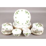 A Colclough eight part bone china tea set in the ivy leaf design. Crack to one cup.