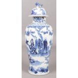 A Chinese lidded baluster shaped vase. Decorated in underglaze blue with landscape scene and
