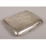 A silver hinged engine turned cigarette case, with circular cartouche to the front. Assayed in