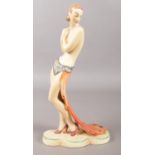 A Czechoslovakian Art Deco pottery figure of a semi naked dancing girl. Impressed and printed