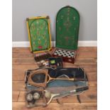 A collection of vintage games, to include bagatelle board, draughts and racket and ball set.