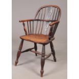A 19th century Windsor arm chair with pierced slat.