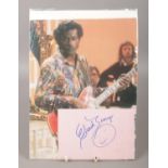 A Chuck Berry autograph with traditional smiley-face doodle and photo of Chuck on stage. No