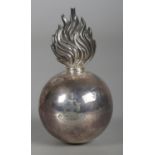 An Edwardian silver military grenade table lighter bearing the Brinkley family coat of arms to one