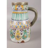 An Iznik style ewer painted with stylized bands in coloured enamels and with later white metal