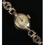 A ladies 9ct gold Gudax manual wristwatch on 9ct gold bracelet strap. 12g.