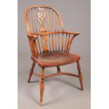 A mid 19th century Windsor arm chair with crinoline stretcher. Height 101.5cm, Width of arms 57cm,