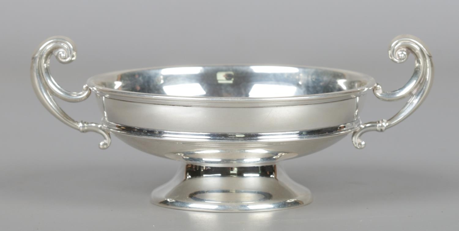 A George V silver twin handled dish. Assayed Birmingham 1926 by William Hutton & Sons Ltd. 90g.