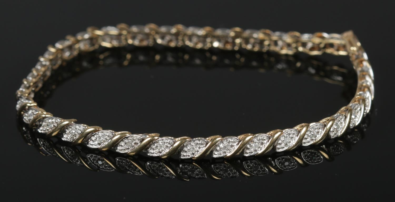 A 9ct gold diamond set bracelet. With 34 small illusion set diamonds. 19cm. 6.99g.