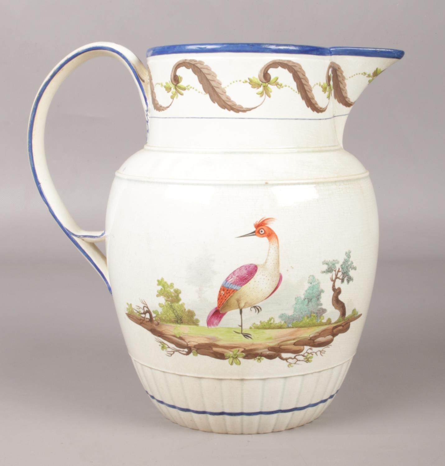 An early 19th century pearlware jug painted in coloured enamels with exotic birds in landscape. - Image 2 of 2