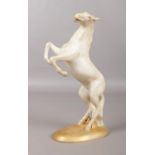 A Royal Dux rearing horse on an oval plinth. Pink Triangle mark on the base. H: 22cm.