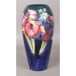 A Walter Moorcroft baluster shaped vase decorated in the Orchid design. Signed to base. 25.5cm.