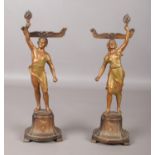 A pair of French spelter menu holders, formed as figures holding torches. 30cm high