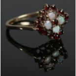 A 9ct Gold, ruby and opal cluster ring, size P½. Total weight: 2.55g.
