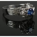 A vintage sapphire and diamond cluster ring. Indistinct markings to the inside of the band - tests