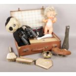 A suitcase of collectables. Includes Art Nouveau pewter vase, dolls, binoculars etc.