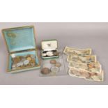 A small collection of foreign currency, paired together with a quantity of commemorative coins and