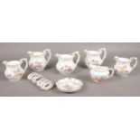 A collection of Royal Crown Derby ceramic's. 'Derby Posies' jugs, pin dish, napkin rings.