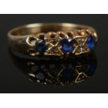 An 18ct Gold and three blue stone ring, set alongside four small diamonds. Size O½. Total weight: