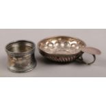 A French silver wine taster/tastevin along with a silver napkin ring. Total weight 58g.