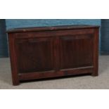 A paneled oak blanket box with hinged top. Height: 58cm, Width: 99cm, Depth: 49cm.