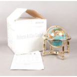 A boxed Gemstone Globe depicting the countries of the World in minerals and semi -precious stones.
