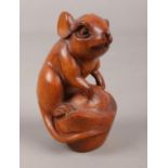 A carved boxwood netsuke formed as a rat.