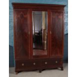 A Victorian mahogany double wardrobe with central mirrored panel and inlay decoration. Height: