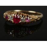 An 18ct Gold, pink ruby and diamond ring. Largest diamond size 1/32 ct. Size O. Total weight: 3.25g.