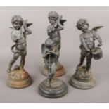 Four spelter figures of cherubs, three examples playing musical instruments.