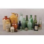 A selection of vintage glass bottles and ceramic flagons and jars. To include H. Handell & Co