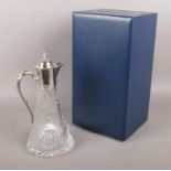 A boxed silver and cut glass claret jug. Assayed Sheffield 2000 by C J Vander Ltd. 29cm.