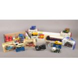 A box of assorted named die-cast vehicles. To include Corgi boxed vehicles, a boxed Lledo truck