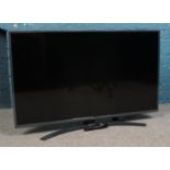 An LG 50" Smart TV with remote. Serial number 50UN74006LB. Tested and is in working order.