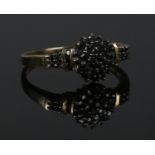 A 9ct gold and dark stone cluster ring. Size R. 2.62g.