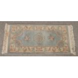 A Chinese wool runner with floral border. (145cm)