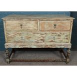 A part painted oak chest of drawers raised on turned support. (77cm x 107cm x 48cm)