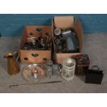 Two boxes of metalwares. Including brass jug, silverplate, napkin rings, tins, etc.