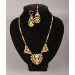 A yellow metal Indian necklace and earring set, inset with turquoise coloured stones.