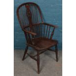 An ash/elm Windsor wheelback armchair. Damage to spinals and frame on back rest.