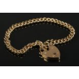 An 18ct gold curb bracelet with heart shaped clasp. Each link stamped. 32g.