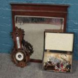 A mahogany framed mirror along with a carved barometer and a walnut box with contents of costume