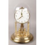 A Bentima torsion clock with glass dome. Height 30cm.