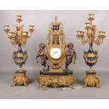 An Italian Imperial gilt metal and marble clock garniture. The clock of lyre form flanked by two