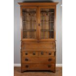 An Art Nouveau oak bureau bookcase, with lead-glazed stained glass panels. Dimensions: Height: